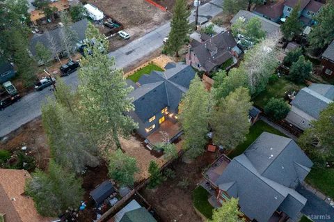 an aerial view of a house with a yard