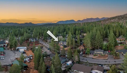 a view of a lush green hillside and a houses