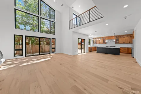 a big room with wooden floor and windows