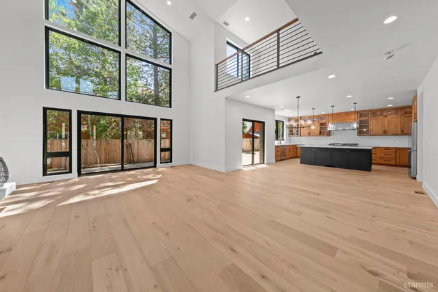 a big room with wooden floor and windows