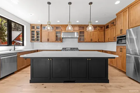 a kitchen with a sink appliances and cabinets