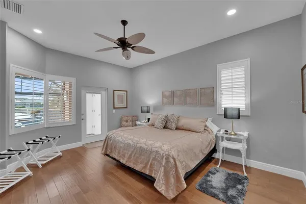 a bedroom with a large bed and a chandelier