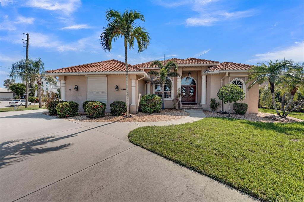 2436 Deborah Drive Punta Gorda, FL 33950 - Photo 3 of 66 a front view of a house with a garden
