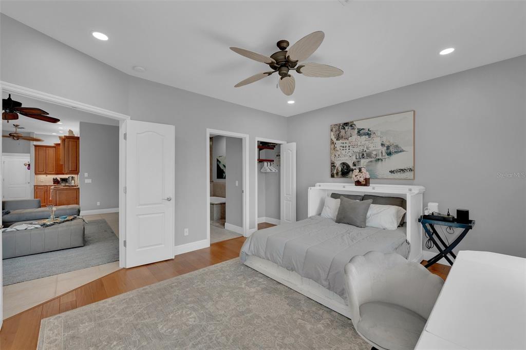 2436 Deborah Drive Punta Gorda, FL 33950 - Photo 32 of 66 a bedroom with a large bed and a chandelier