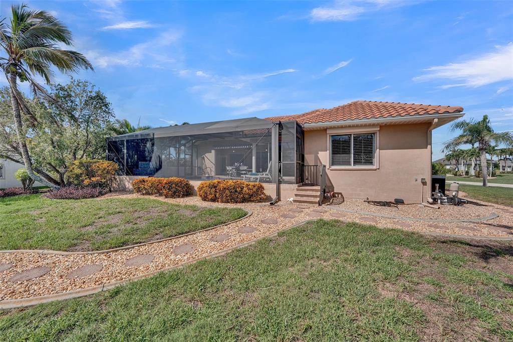 2436 Deborah Drive Punta Gorda, FL 33950 - Photo 40 of 66 a front view of a house with a garden