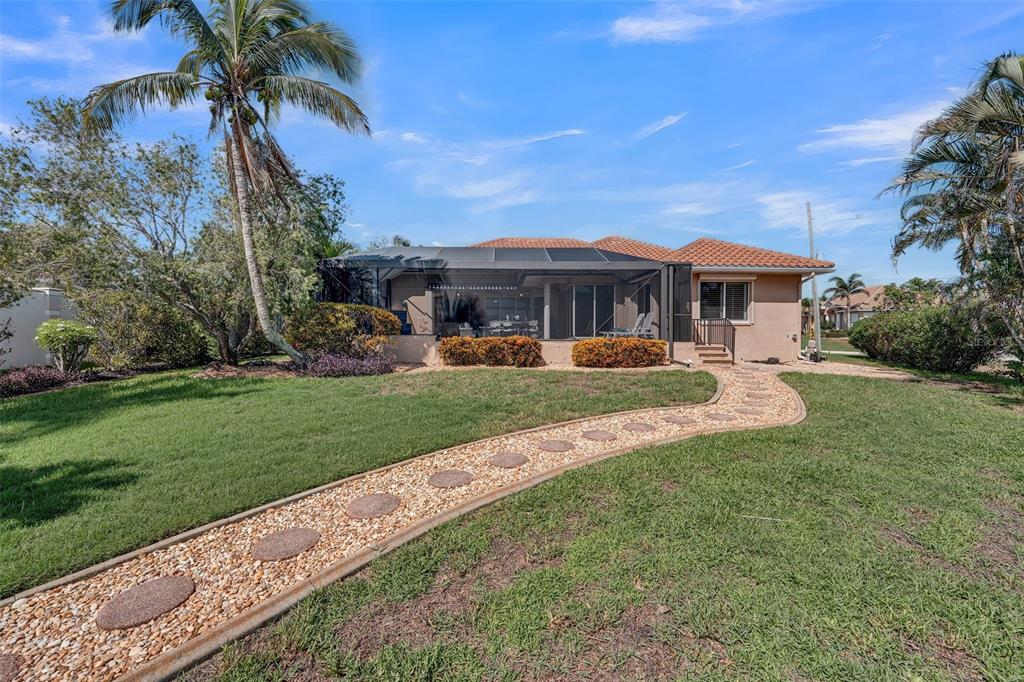 2436 Deborah Drive Punta Gorda, FL 33950 - Photo 4 of 66 a front view of a house with a yard table and chairs