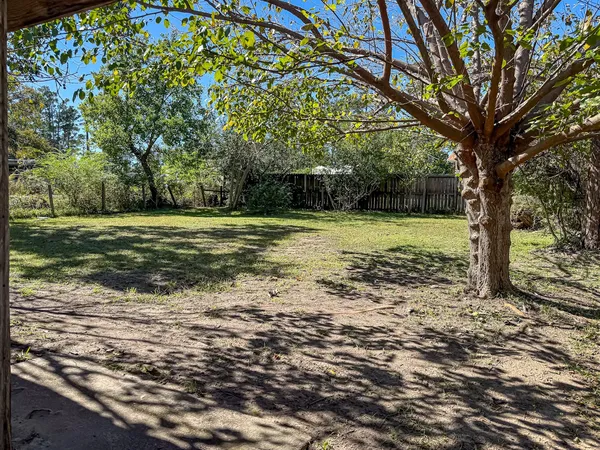a view of a wooden house with a yard