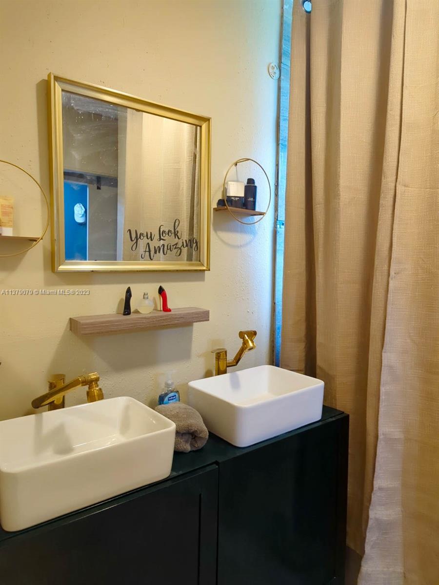 14735 Southwest 302nd Street Homestead, FL 33033 - Photo 11 of 23 a bathroom with a sink and a mirror