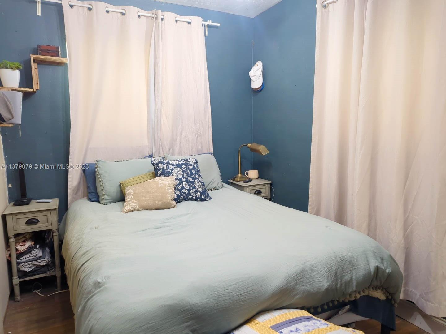 14735 Southwest 302nd Street Homestead, FL 33033 - Photo 16 of 23 a bedroom with a bed and a window