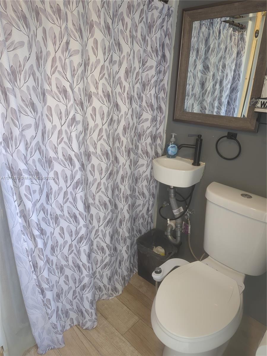 14735 Southwest 302nd Street Homestead, FL 33033 - Photo 18 of 23 a bathroom with a toilet and a sink