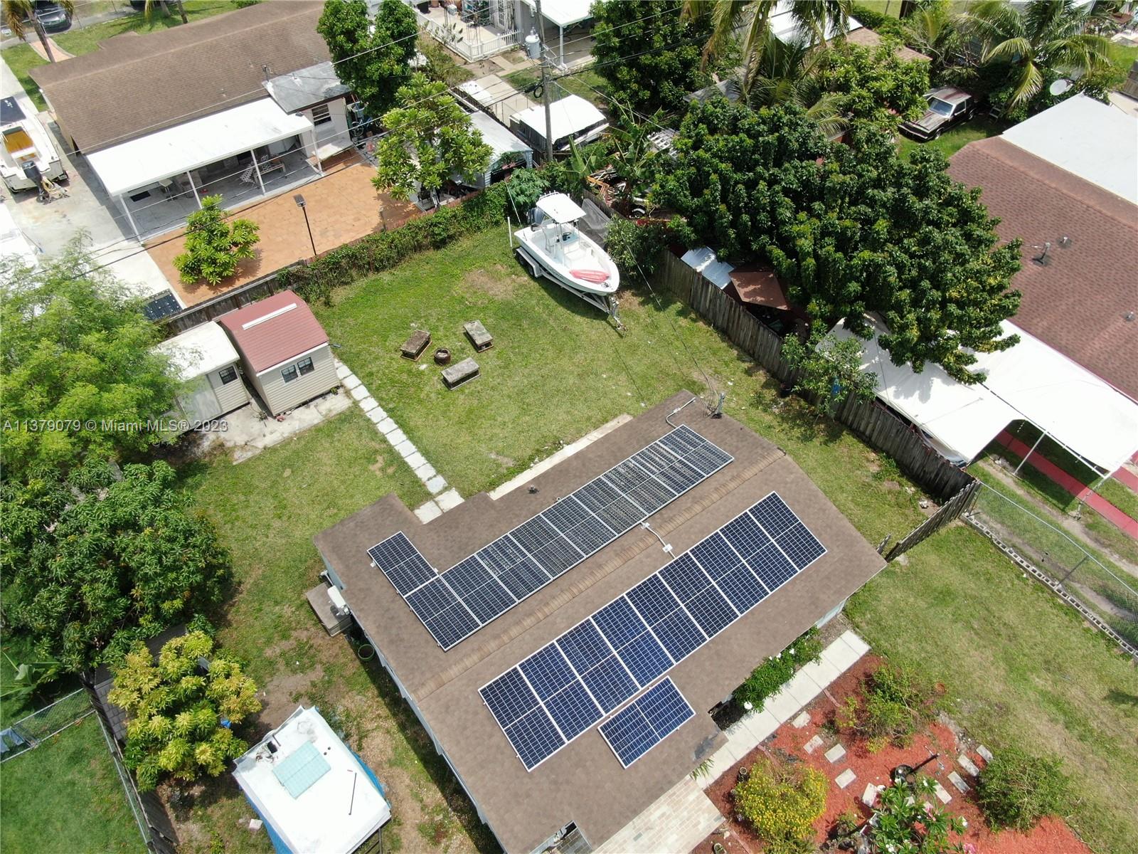 14735 Southwest 302nd Street Homestead, FL 33033 - Photo 2 of 23 an aerial view of a house with a garden