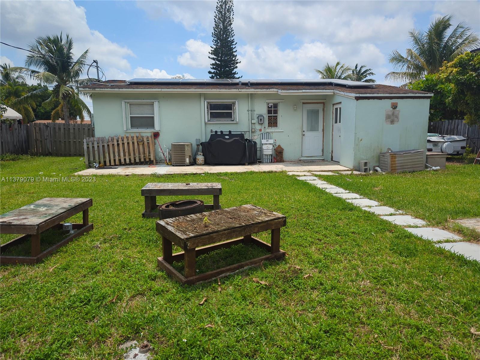 14735 Southwest 302nd Street Homestead, FL 33033 - Photo 21 of 23 a front view of house with yard and outdoor seating