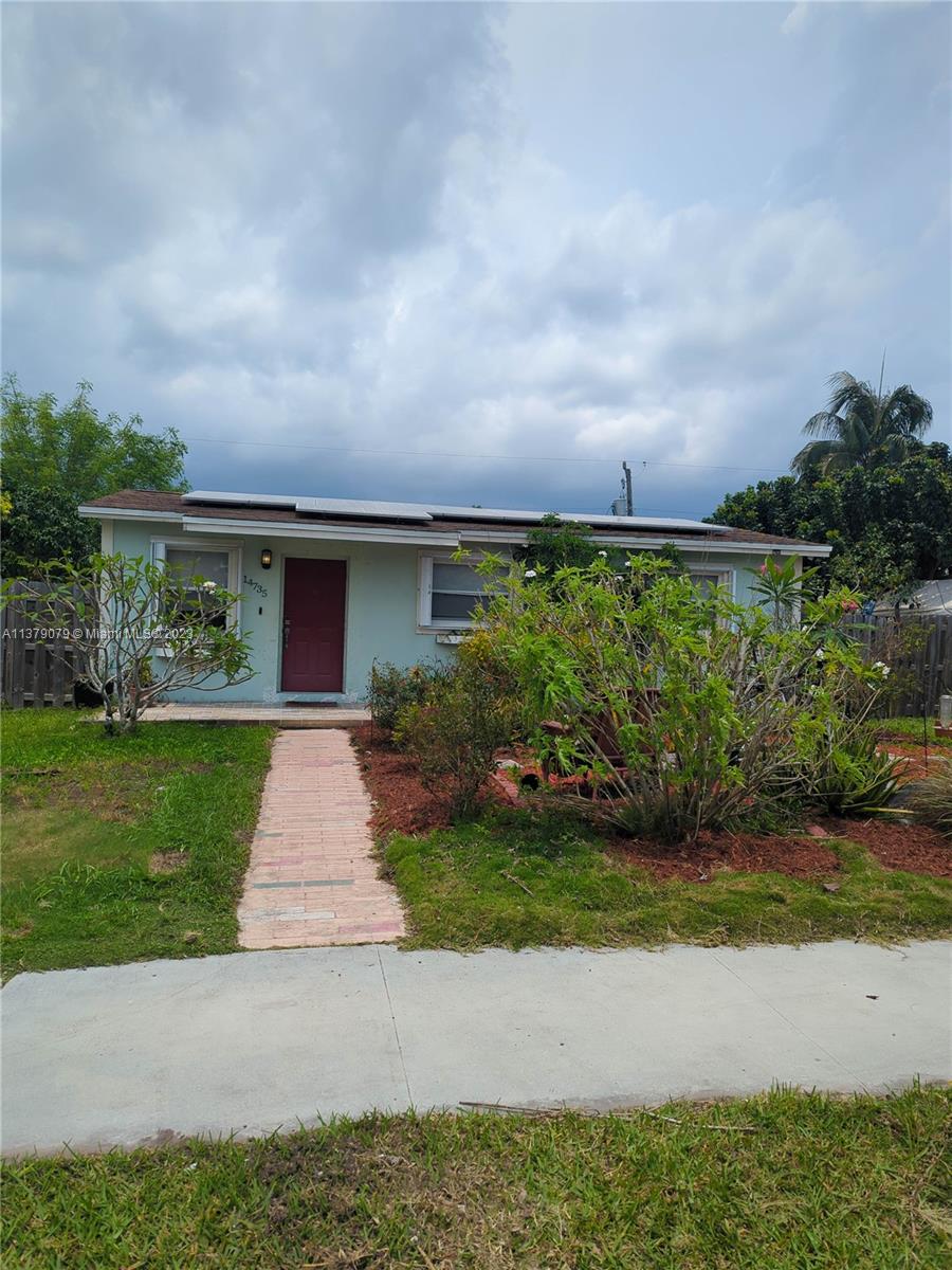 14735 Southwest 302nd Street Homestead, FL 33033 - Photo 22 of 23 a front view of a house with a yard