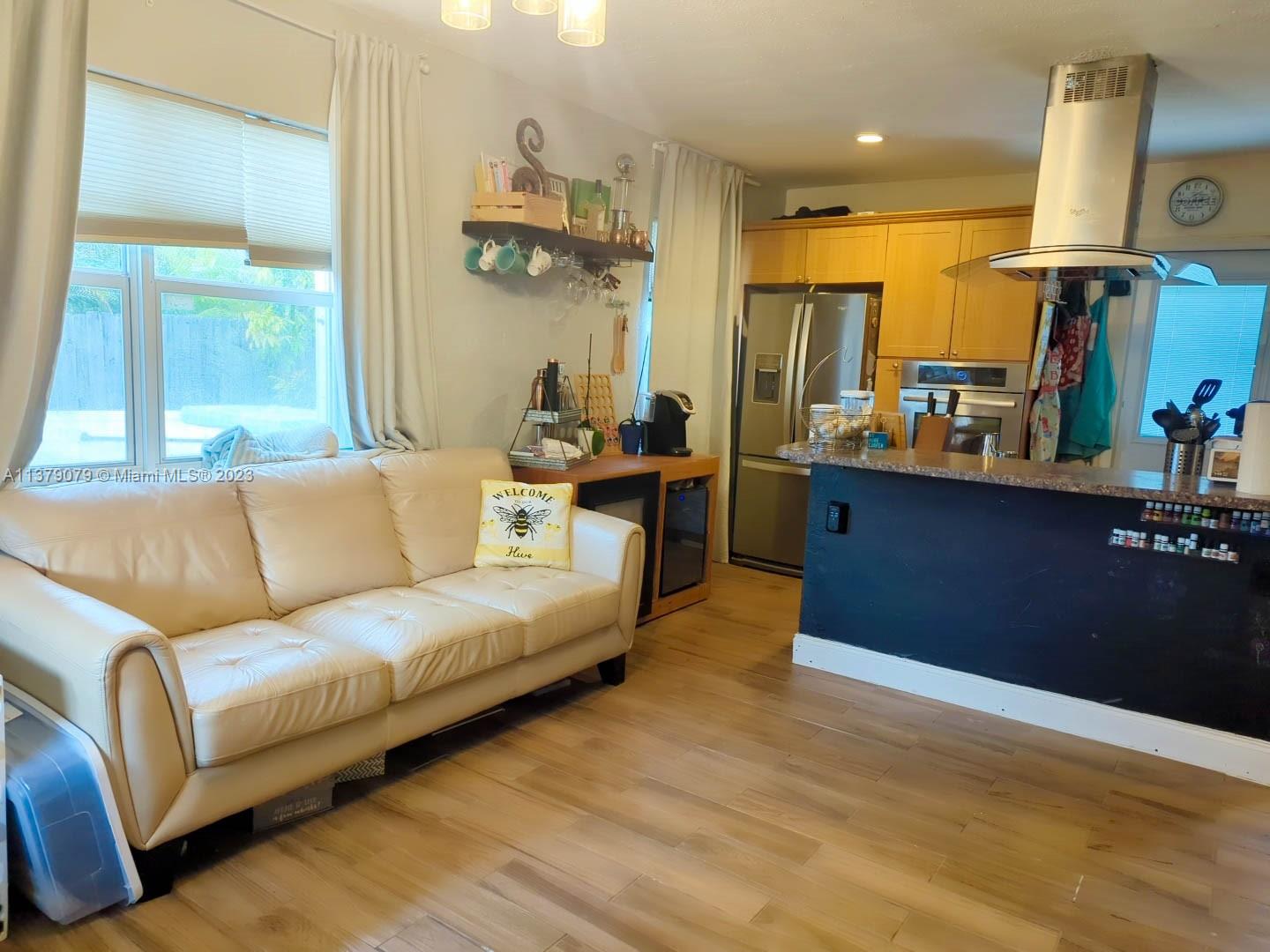 14735 Southwest 302nd Street Homestead, FL 33033 - Photo 5 of 23 a living room with furniture kitchen view and a large window