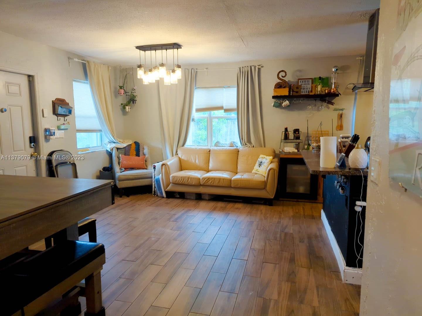 14735 Southwest 302nd Street Homestead, FL 33033 - Photo 6 of 23 a living room with furniture and a wooden floor