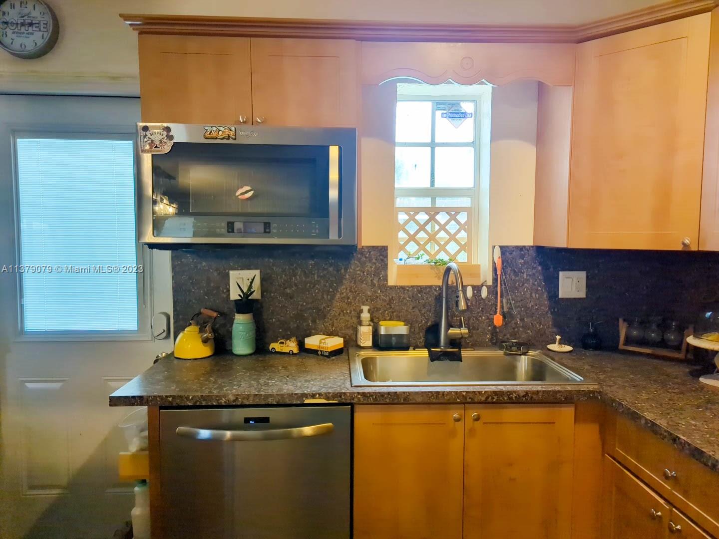 14735 Southwest 302nd Street Homestead, FL 33033 - Photo 9 of 23 a kitchen with a sink and a window