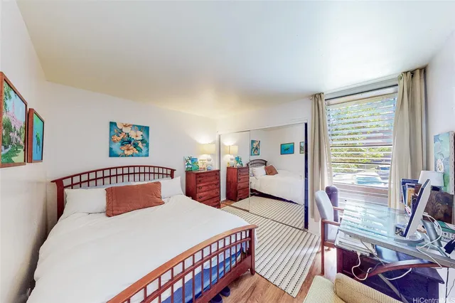 a bedroom with furniture and a large window