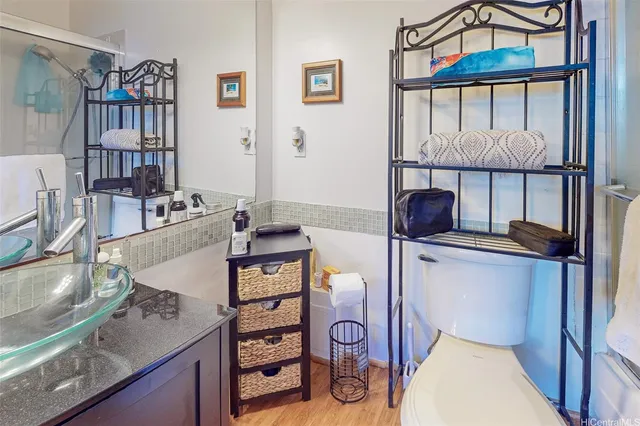 a bathroom with a toilet a sink and a mirror