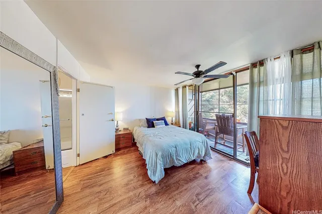 a room with a bed and wooden floor