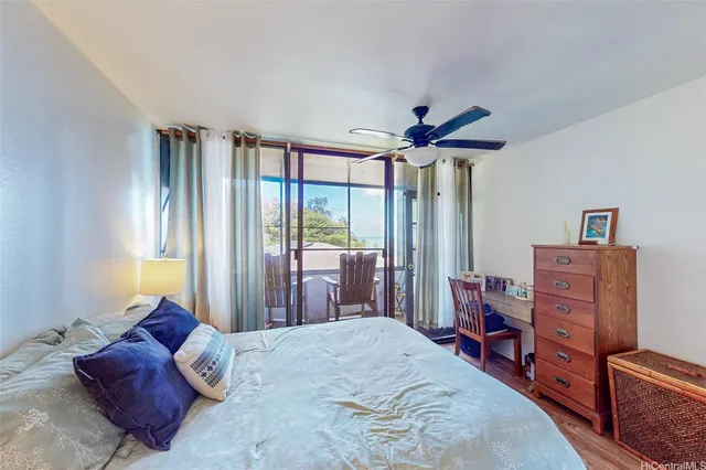 a bedroom with a bed a chandelier and a dresser