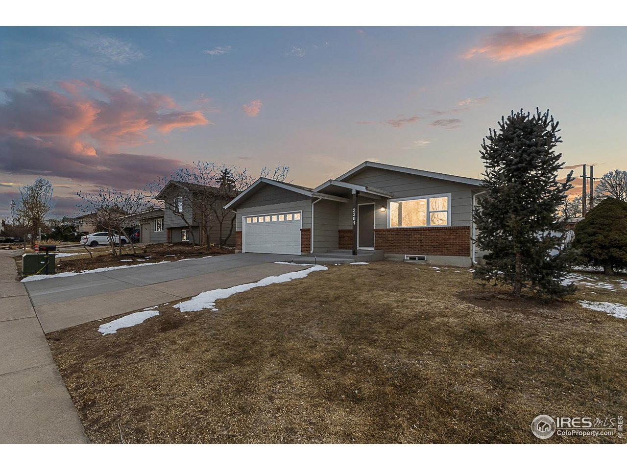 2301 33rd Avenue Greeley, CO 80634 - Photo 2 of 50 a front view of a house with a yard and garage