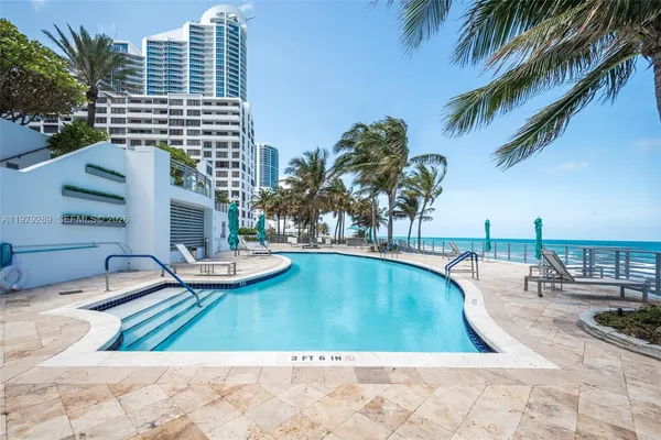 a view of a swimming pool and lounge chair