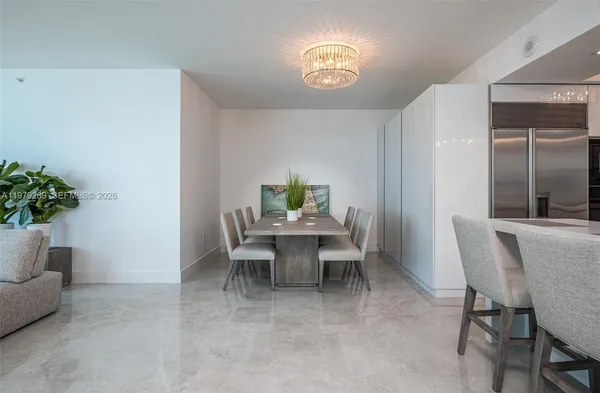 a view of a dining room with a table and chairs
