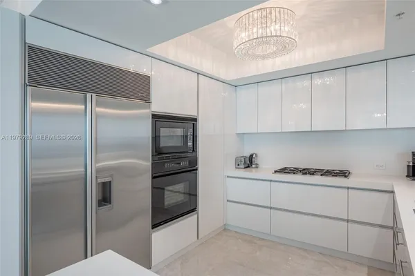 a kitchen with cabinets and stainless steel appliances