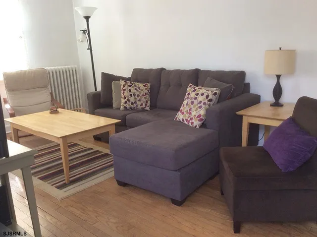 a living room with furniture and a lamp