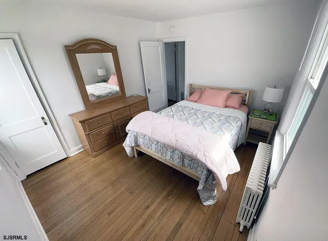 a bedroom with a bed and a mirror