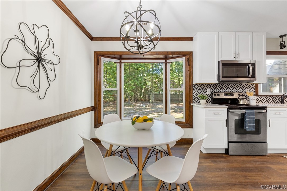 6940 Manning Road Chesterfield, VA 23832 - Photo 11 of 29 Wood floored dining room with an inviting chandeli