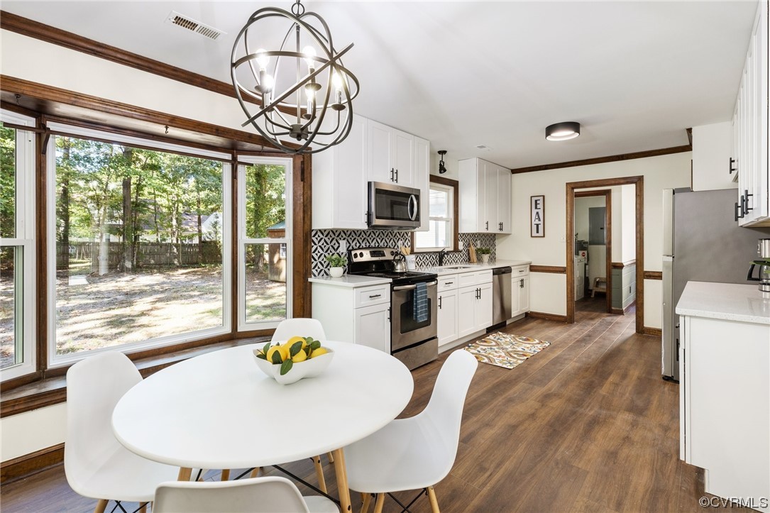 6940 Manning Road Chesterfield, VA 23832 - Photo 6 of 29 Kitchen featuring white cabinets, hanging light fi