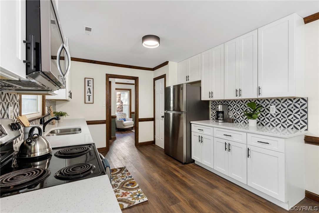 6940 Manning Road Chesterfield, VA 23832 - Photo 8 of 29 Kitchen with sink, white cabinets, backsplash, dar