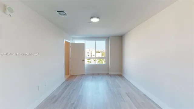 a view of hallway with wooden floor