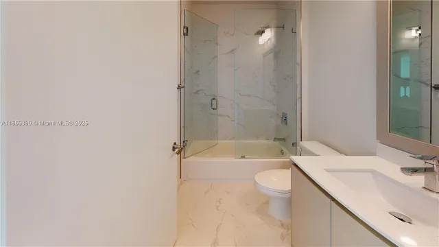 a bathroom with a granite countertop window and a sink