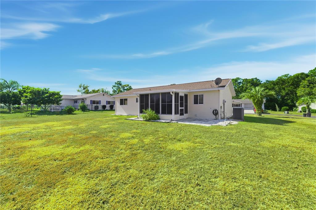 10949 Southwest 79th Terrace Ocala, FL 34476 - Photo 16 of 18 a view of a house with a big yard
