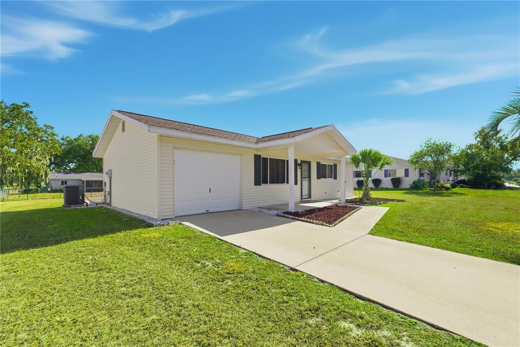 10949 Southwest 79th Terrace Ocala, FL 34476 - Photo 2 of 18 a front view of house with yard and green space