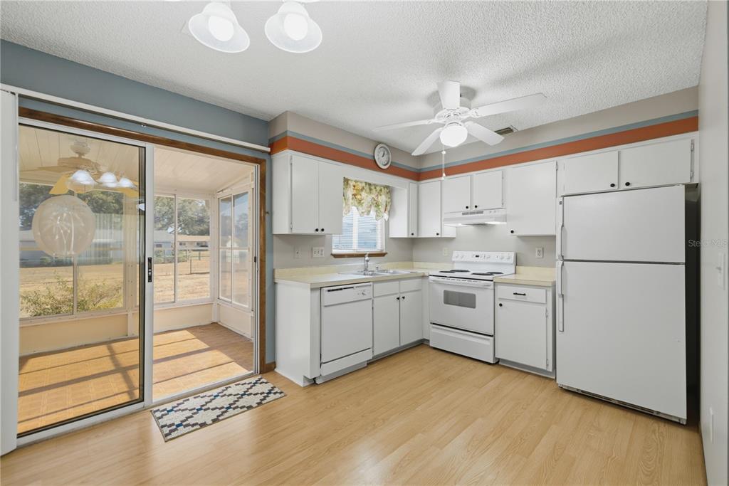 10949 Southwest 79th Terrace Ocala, FL 34476 - Photo 7 of 18 a kitchen with white cabinets and white appliances