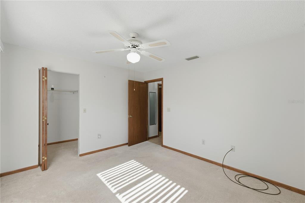 10949 Southwest 79th Terrace Ocala, FL 34476 - Photo 9 of 18 a view of an empty room with a fan