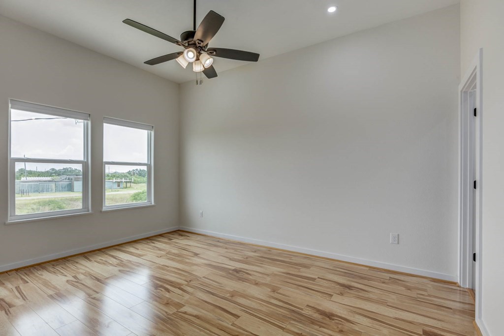 13 Bayview Loop Rockport, TX 78382 - Photo 16 of 26 wooden floor in an empty room with a window