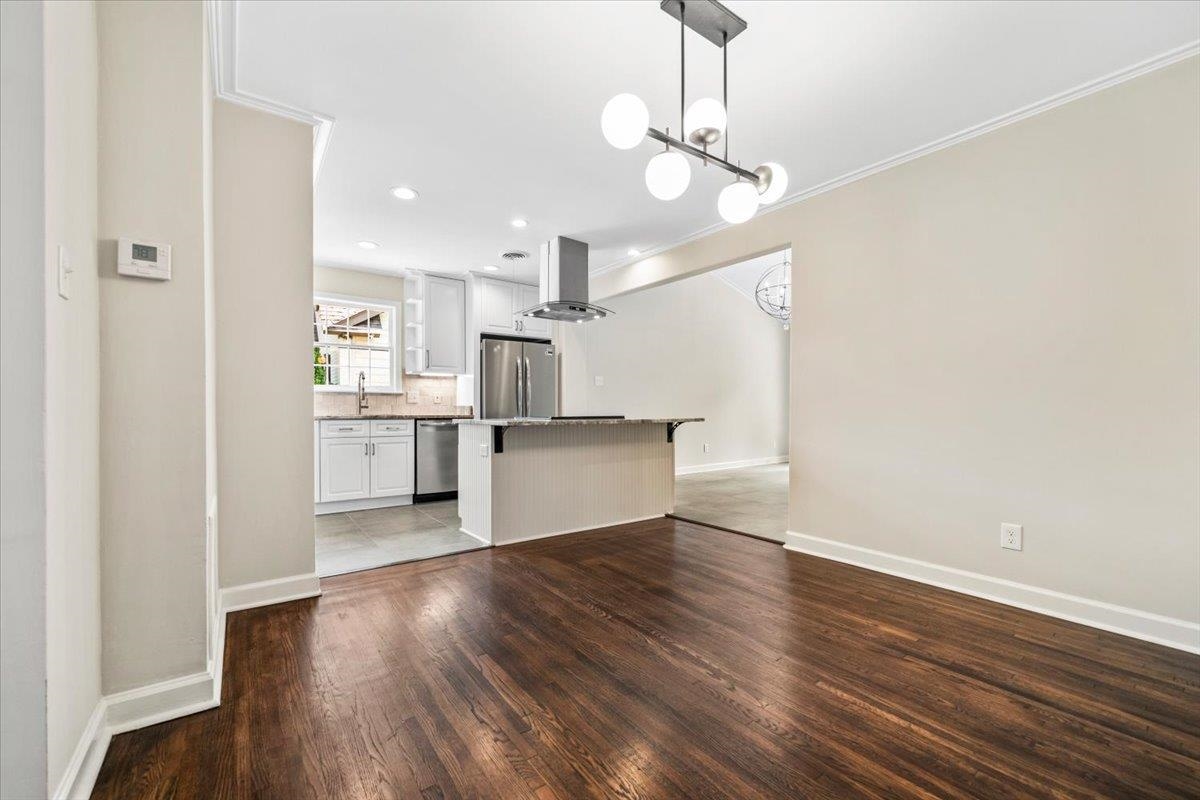 170 South Greer Street Memphis, TN 38111 - Photo 34 of 35 Expansive wood-finish flooring extends throughout, complemented by a contemporary chandelier