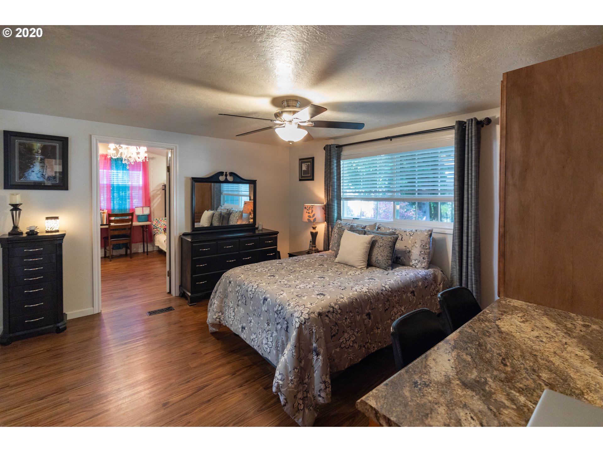 32487 Southeast Colorado Road Sandy, OR 97055 - Photo 11 of 31 a bedroom with a bed and a flat screen tv