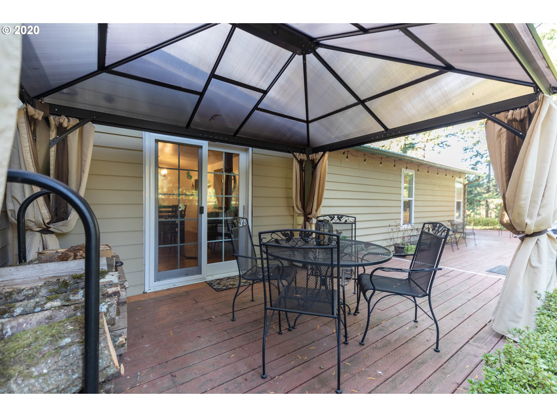 32487 Southeast Colorado Road Sandy, OR 97055 - Photo 18 of 31 a view of a patio with table and chairs under an umbrella