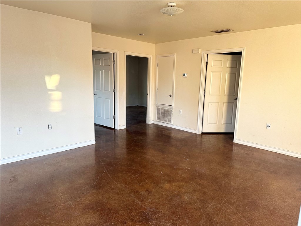 201 Edwards Street Corpus Christi, TX 78404 - Photo 2 of 10 an empty room with wooden floor and windows