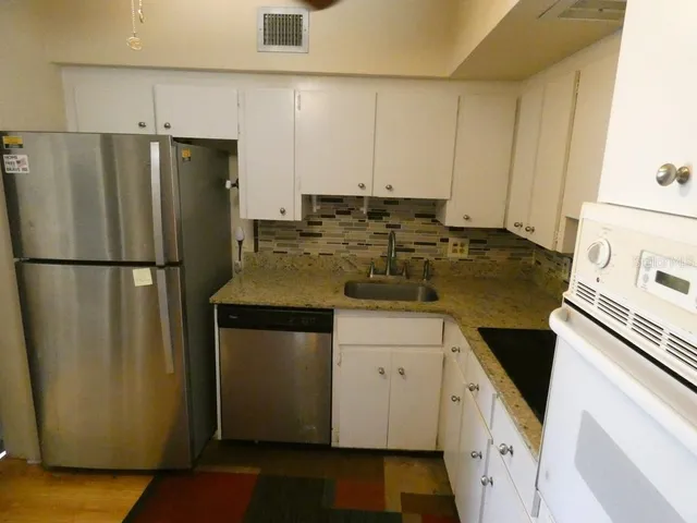 a kitchen with a refrigerator and a sink