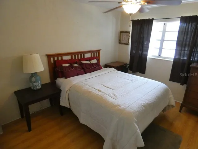 a bedroom with a bed and window
