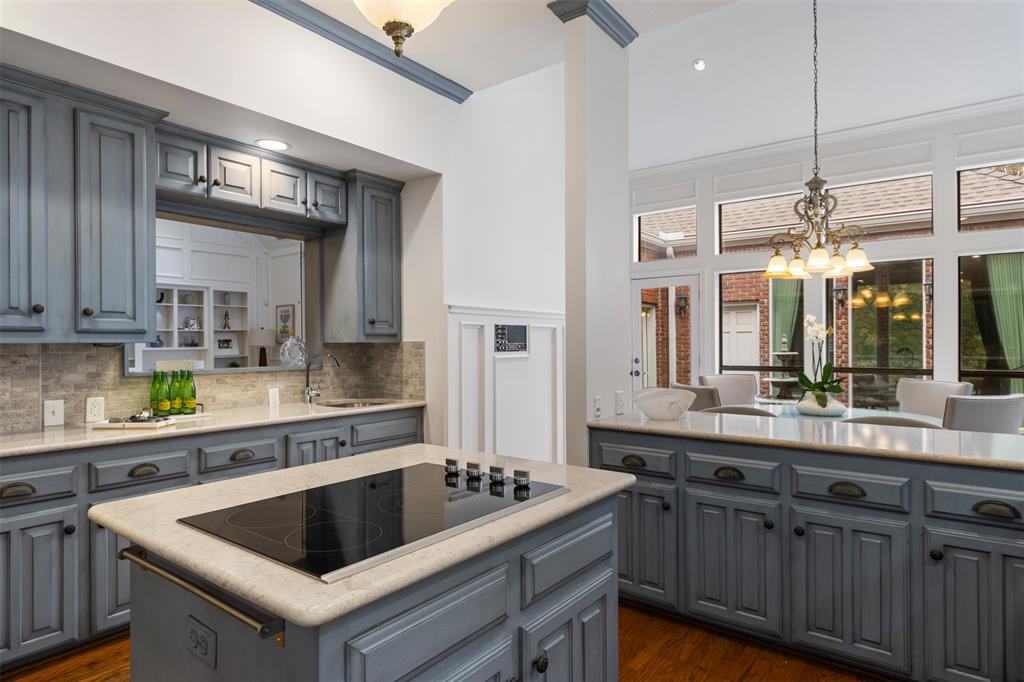 7 Queensview Court Dallas, TX 75225 - Photo 18 of 40 a kitchen with a sink a counter top space and cabinets