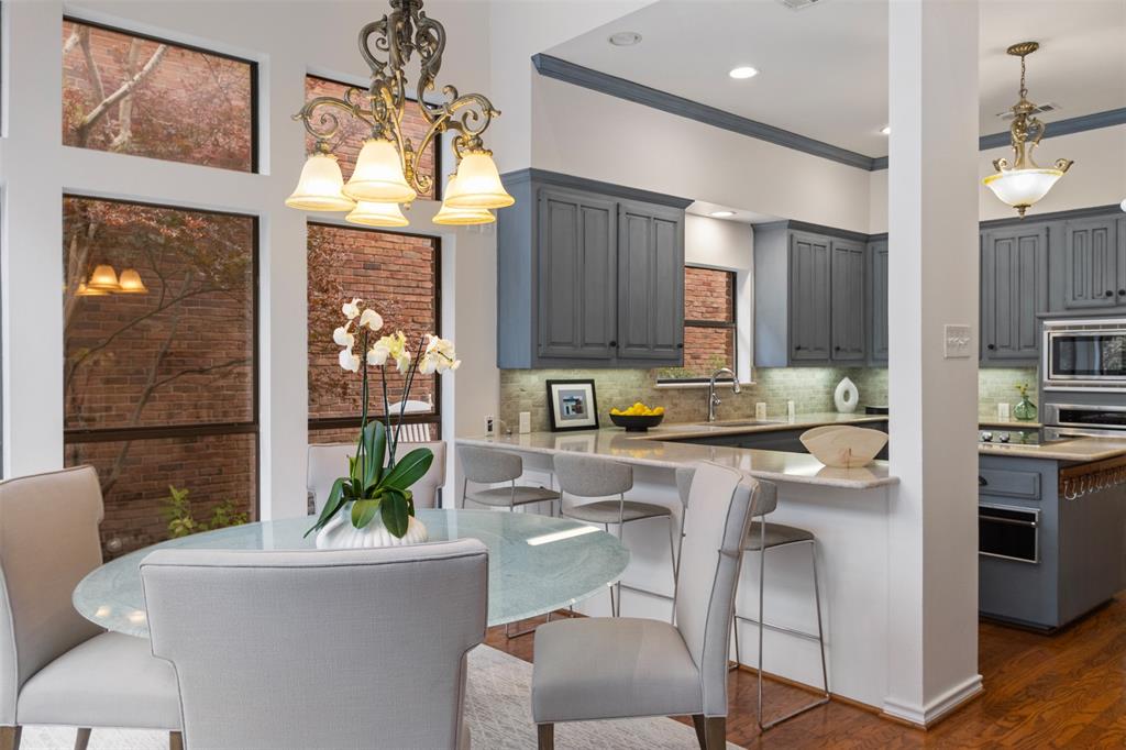 7 Queensview Court Dallas, TX 75225 - Photo 21 of 40 a kitchen with a table chairs refrigerator and microwave