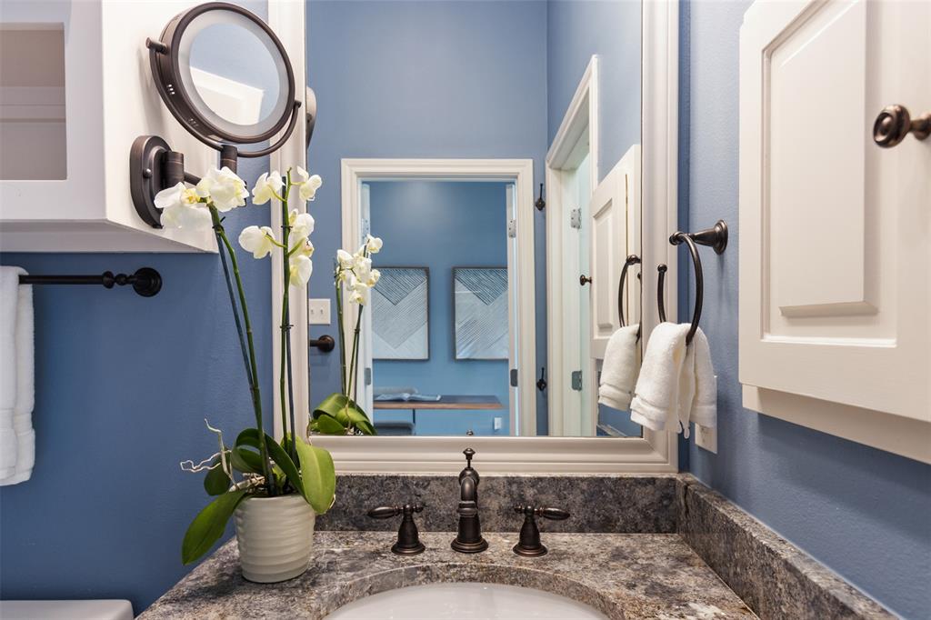 7 Queensview Court Dallas, TX 75225 - Photo 34 of 40 a bathroom with a granite countertop sink a toilet and a mirror