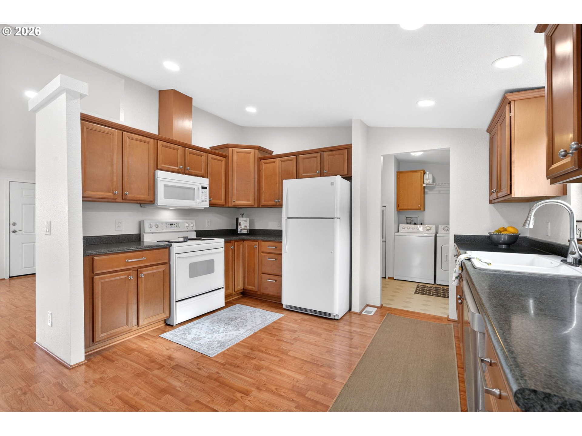110 South Harrison Street Newberg, OR 97132 - Photo 8 of 41 a kitchen with refrigerator cabinets and wooden floor